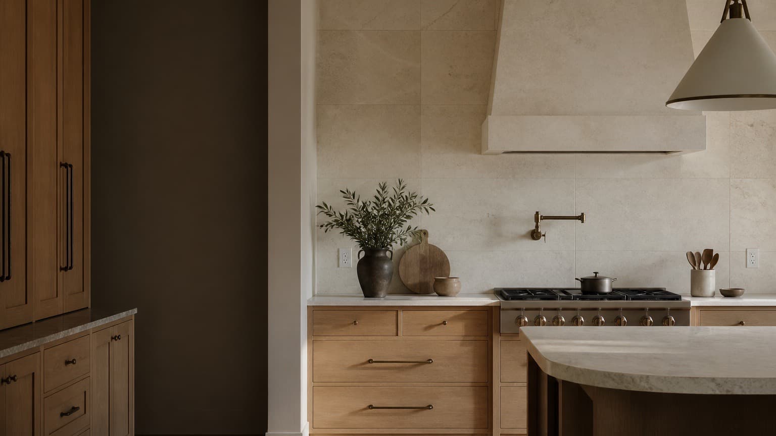 Concept refined kitchen with full-height stone backsplash, oak cabinetry, and bronze details